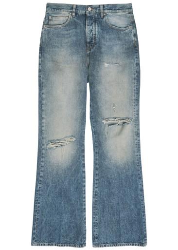 Slashed distressed bootcut jeans by AMIRI