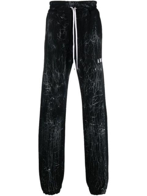 cracked-dye logo track pants by AMIRI