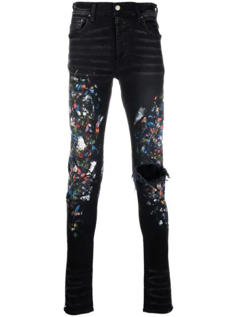 paint print distressed skinny jeans by AMIRI