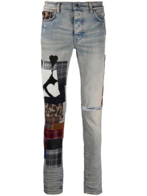 patchwork-detail denim jeans by AMIRI
