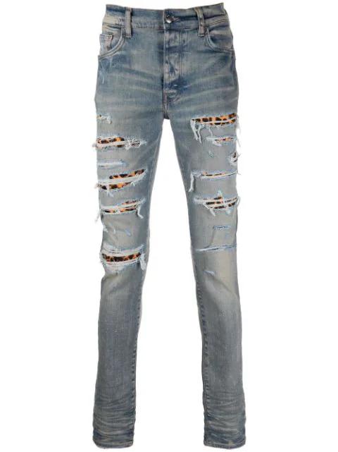 ripped-detail jeans by AMIRI