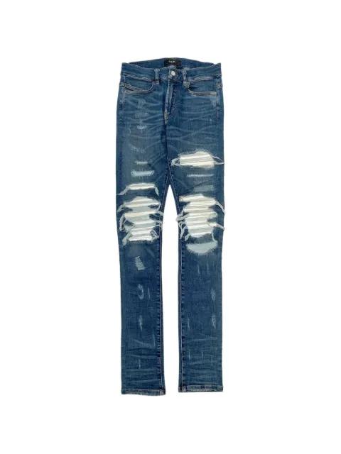 ripped-effect jeans by AMIRI