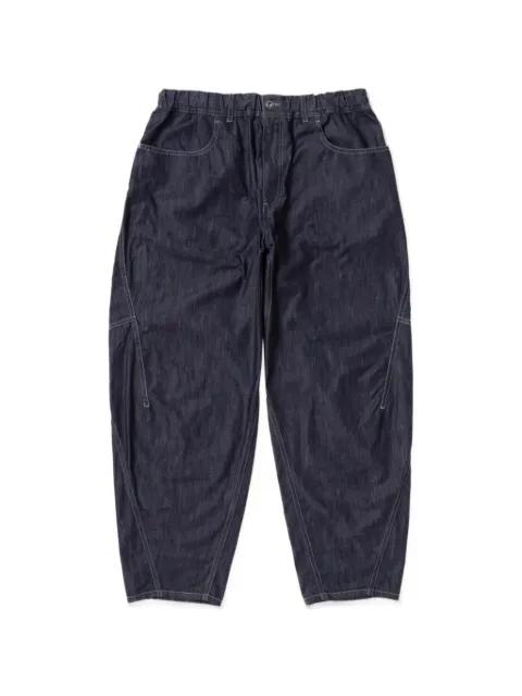 contrast-stitch trousers by AND WANDER