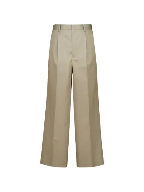 pleated wool trousers by AURALEE