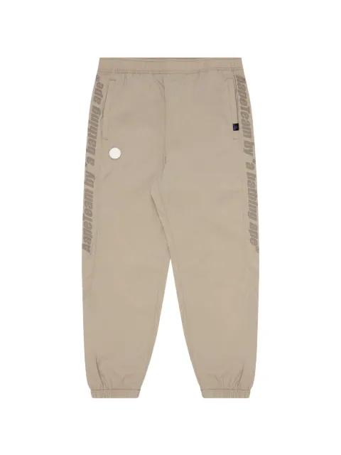 Moonface logo-tape track pants by BAPE