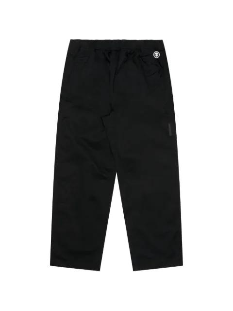 Moonface-patch trousers by BAPE