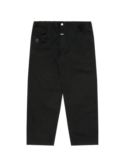 Moonface-patch trousers by BAPE