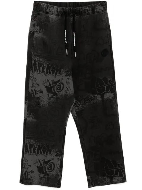 graffiti-print track pants by BAPE