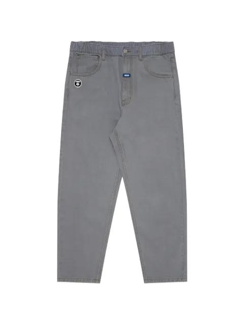 moonface-patch jeans by BAPE