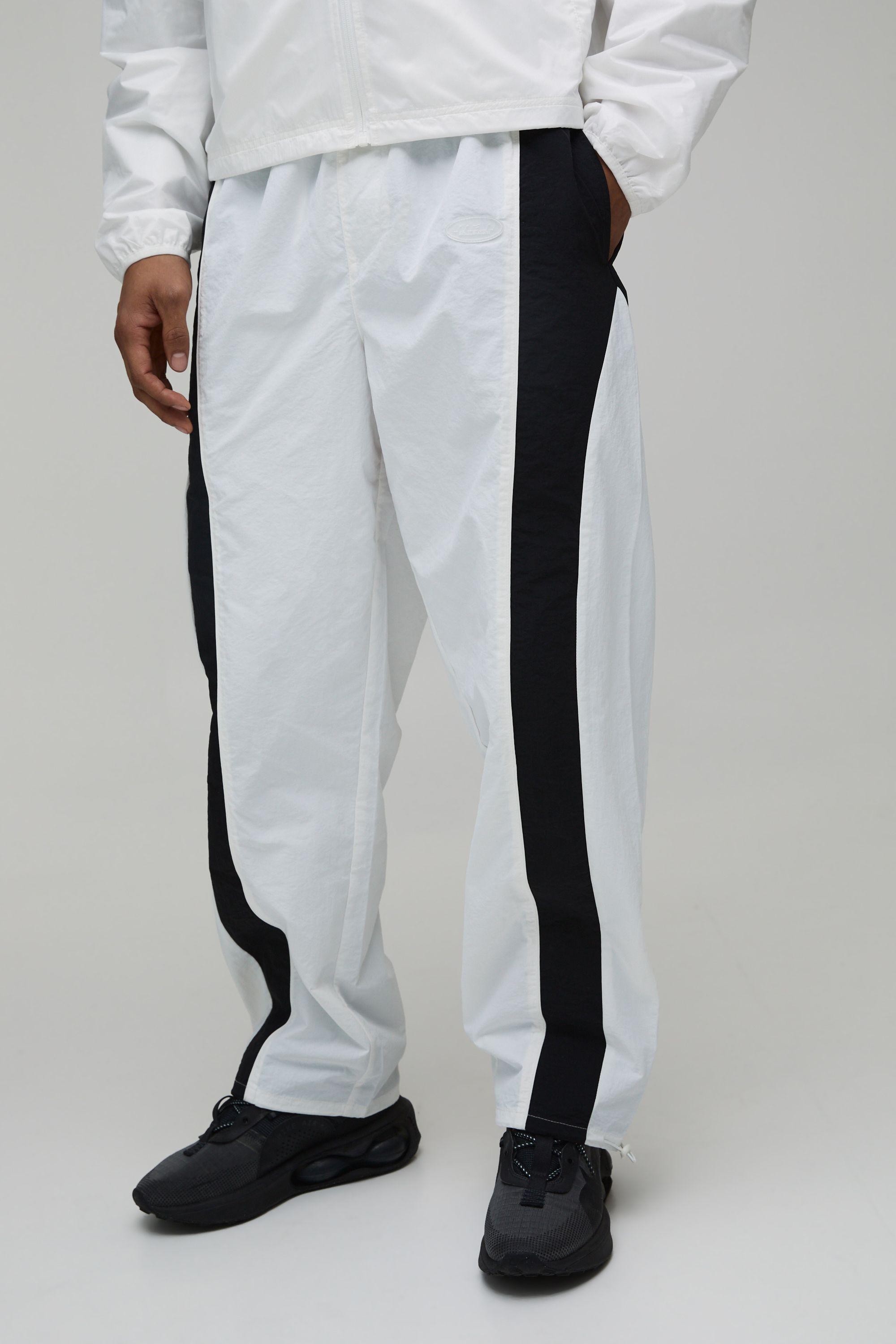 Relaxed Fit Curve Panel and Binding Toggle Hem Nylon Track Pants by BOOHOOMAN