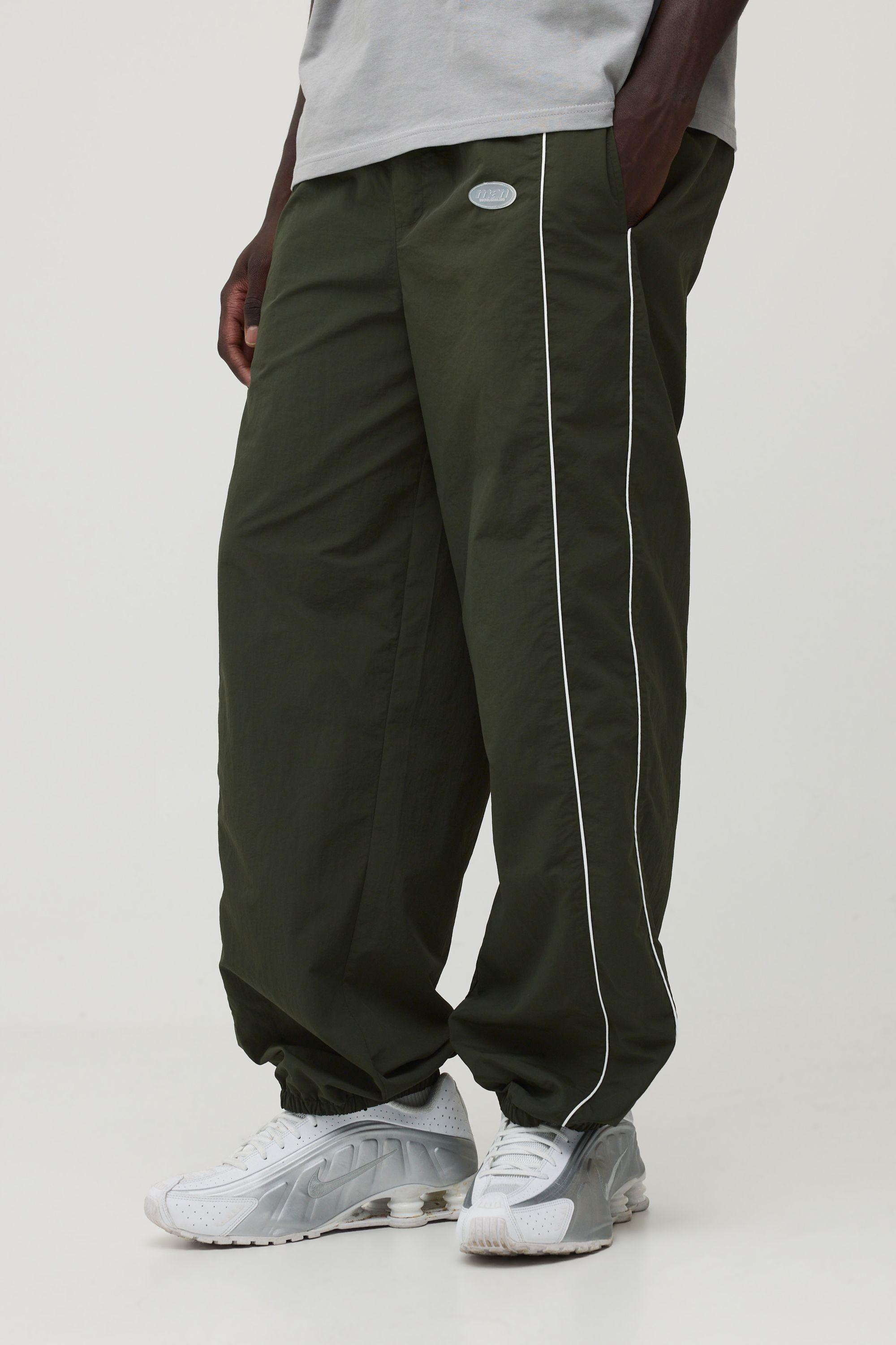 Relaxed Fit Elasticated Front Binding Toggle Hem Nylon Track Pants by BOOHOOMAN