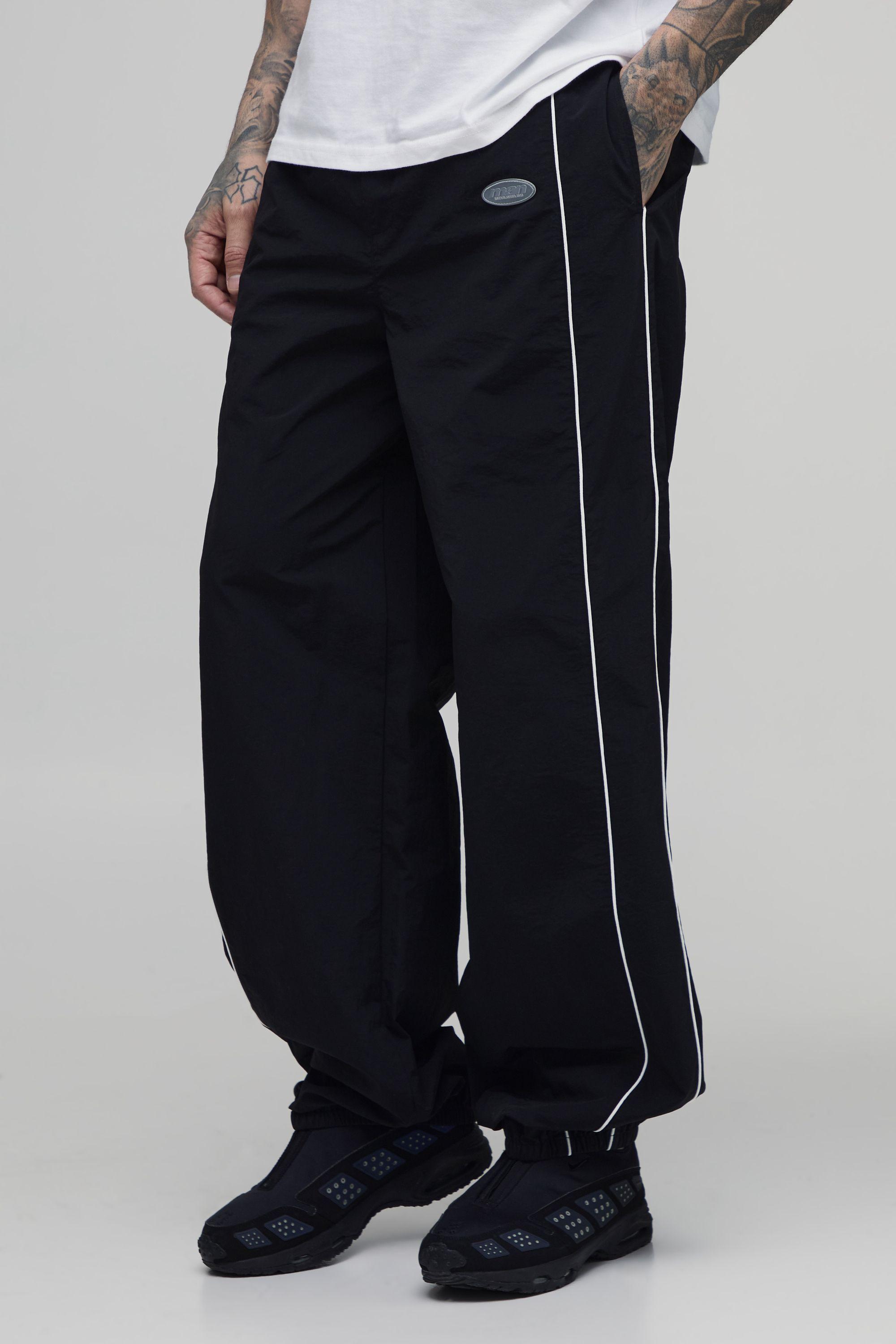 Tall Relaxed Fit Elasticated Front Binding Toggle Hem Track Pants by BOOHOOMAN