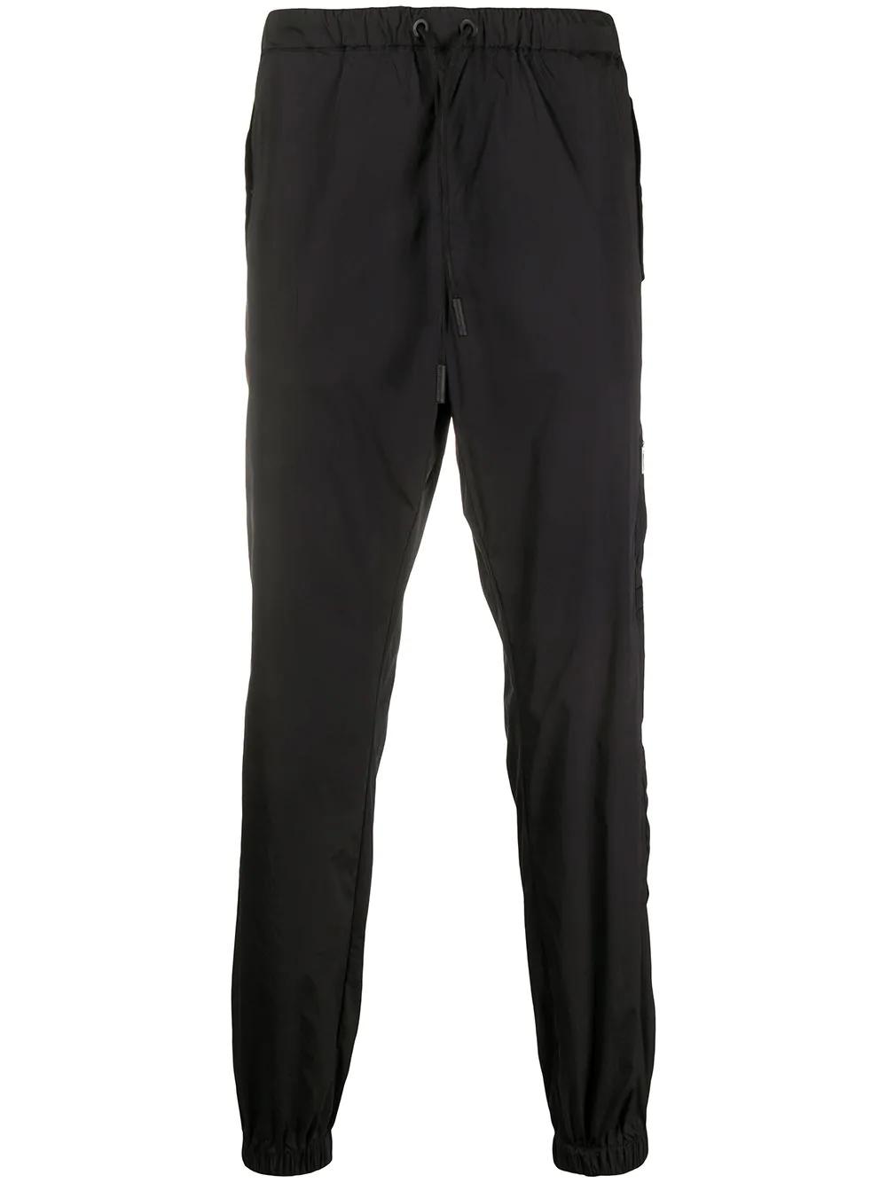 Cross tapered track pants by COUNTY OF MILAN