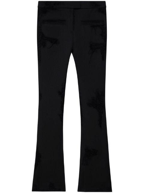 distressed-effect flared trousers by COURREGES