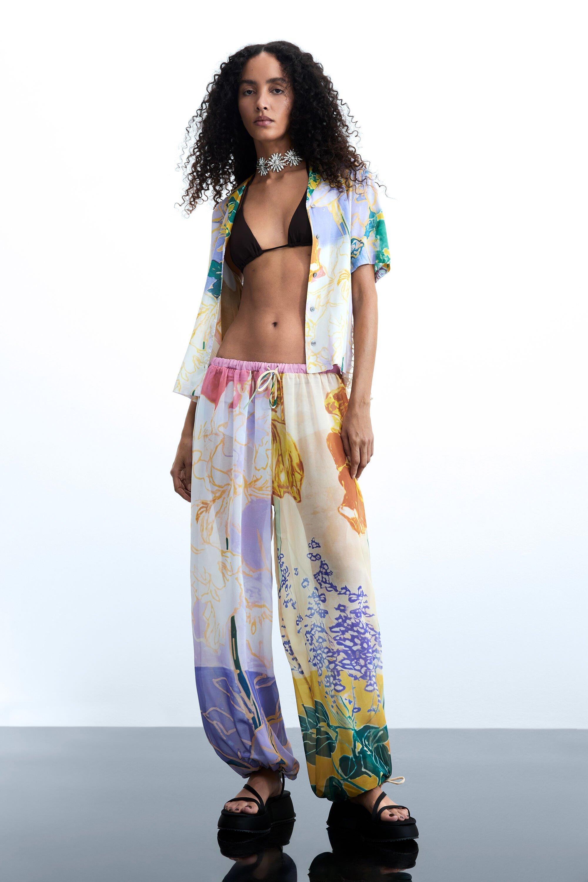 Long floral print trousers by DESIGUAL