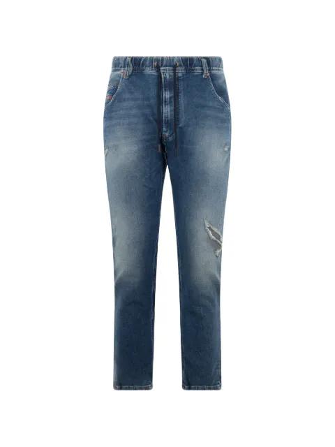 distressed tapered jeans by DIESEL