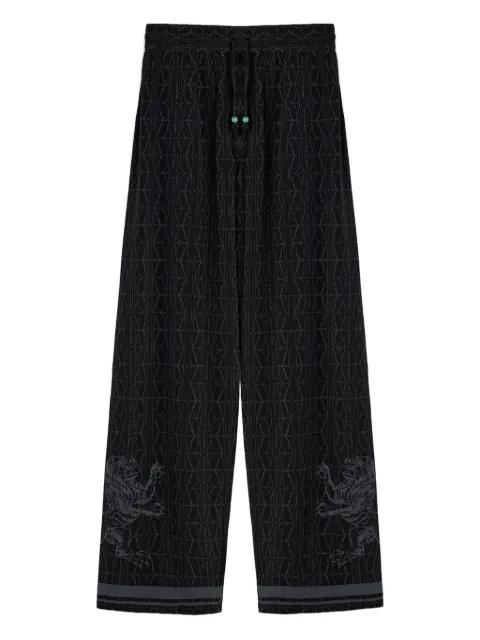 lion-embellished patterned silk trousers by DOMAINE DES ARTISTES