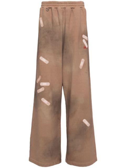 tape-embroidered track pants by DOUBLET
