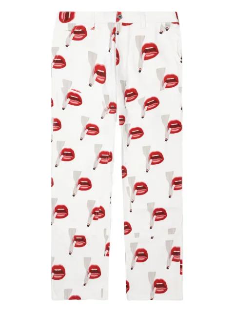 x Tom Wesselmann smoking lips-print trousers by EMOTIONALLY UNAVAILABLE