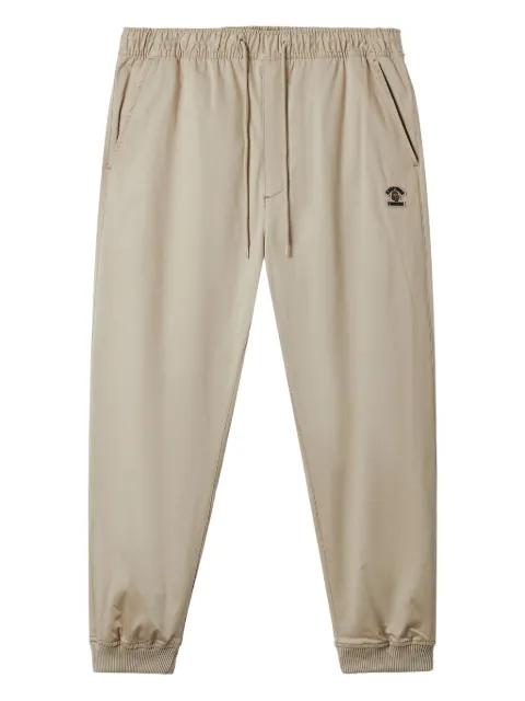 logo-patch cuffed trousers by FINGERCROXX