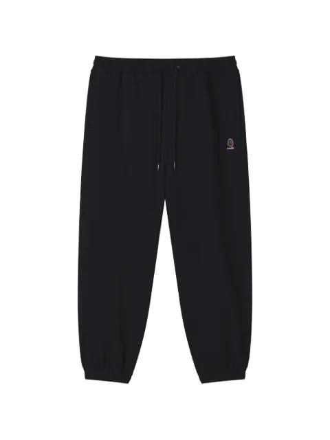 logo-patch trousers by FINGERCROXX