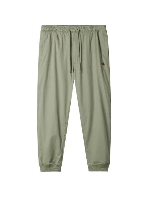 logo-patch trousers by FINGERCROXX