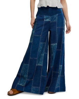 Patches Mid Rise Wide Leg Flare Jeans in Indigo Patch by FREE PEOPLE