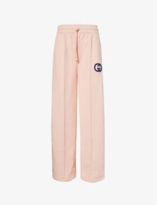 Brand-print relaxed-fit cotton-jersey jogging bottoms by GUCCI