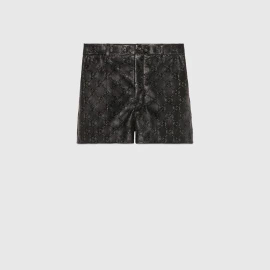 GG embossed leather shorts in black by GUCCI