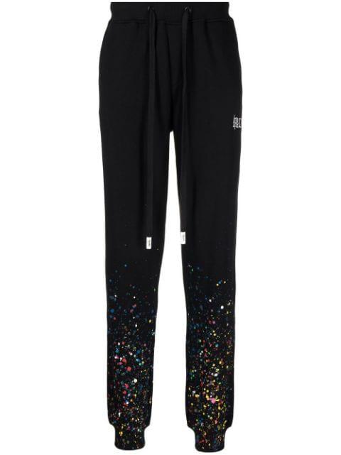 paint splatter track pants by HACULLA