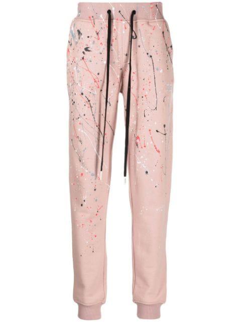 paint-splatter track pants by HACULLA