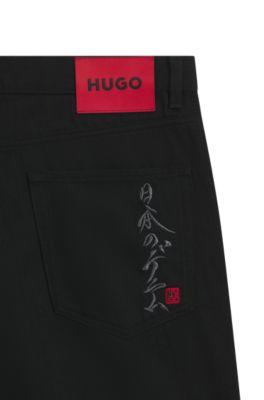 Black tapered-fit jeans in Japanese denim by HUGO BOSS