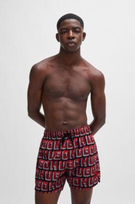 Quick-dry swim shorts with all-over logo print by HUGO BOSS