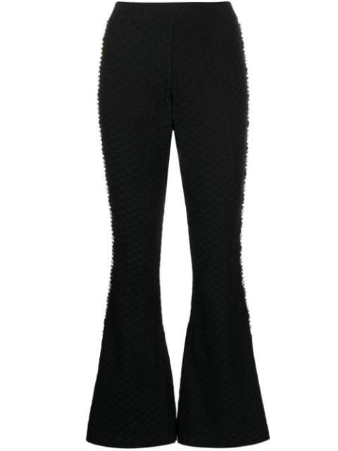 knitted embellished flared trousers by IZAAK AZANEI