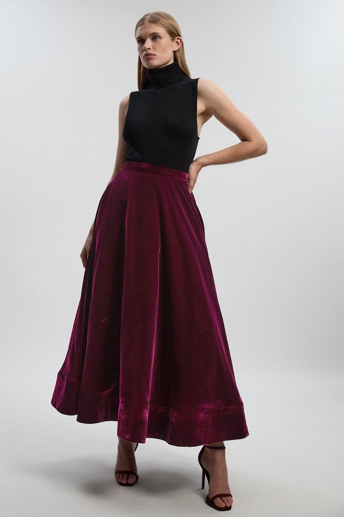 Woman in velvet midi skirt with fitted turtleneck