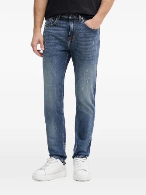 distressed logo-patch jeans by KARL LAGERFELD