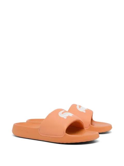 Serve crocodile-embossed slides by LACOSTE