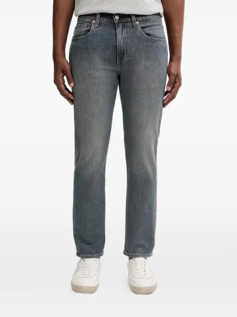 502 button tapered jeans by LEVIS