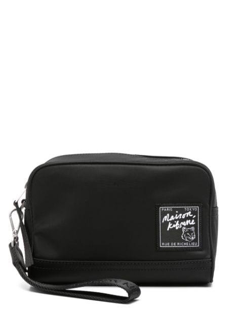 The Traveller clutch bag by MAISON KITSUNE