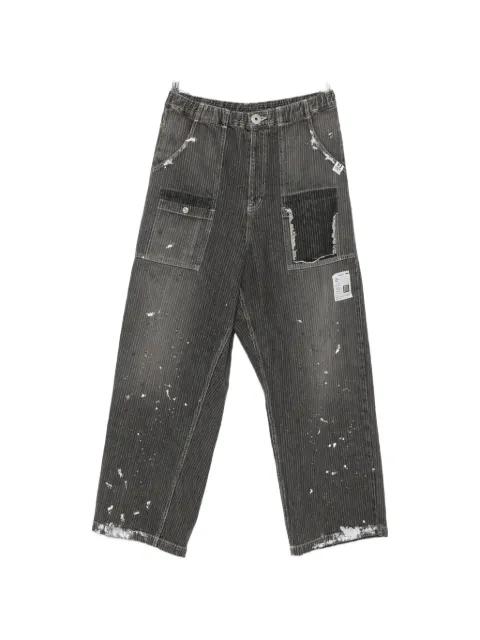 paint-splatter distressed jeans by MAISON MIHARA YASUHIRO