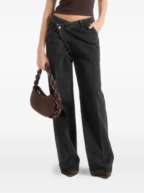 Astrid in washed black wrapover wide leg jeans by MANIERE DE VOIR