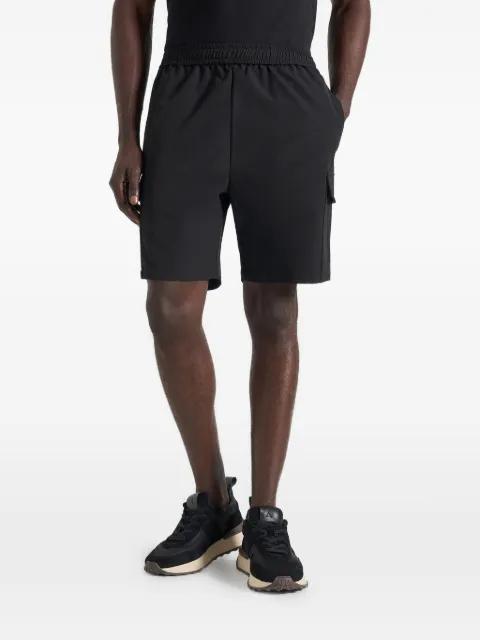 Dimitri in black technical cargo shorts by MANIERE DE VOIR