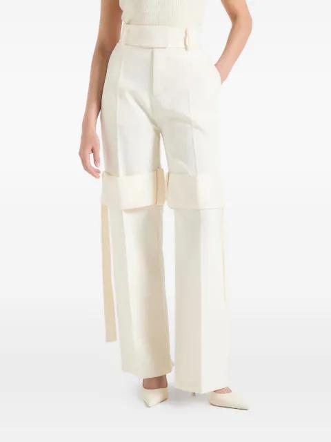 Isabelle in off-white tailored belted strap-detail trousers by MANIERE DE VOIR