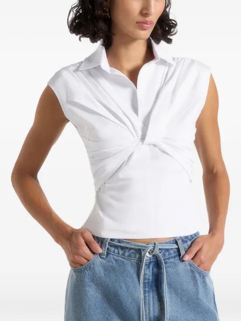 Yvette in white twist-front sleeveless shirt by MANIERE DE VOIR