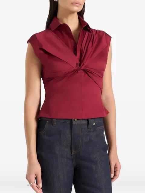 Yvette in wine red twist-front sleeveless shirt by MANIERE DE VOIR