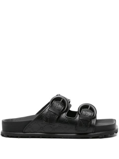 Moonogram-embossed leather slides by MARINE SERRE