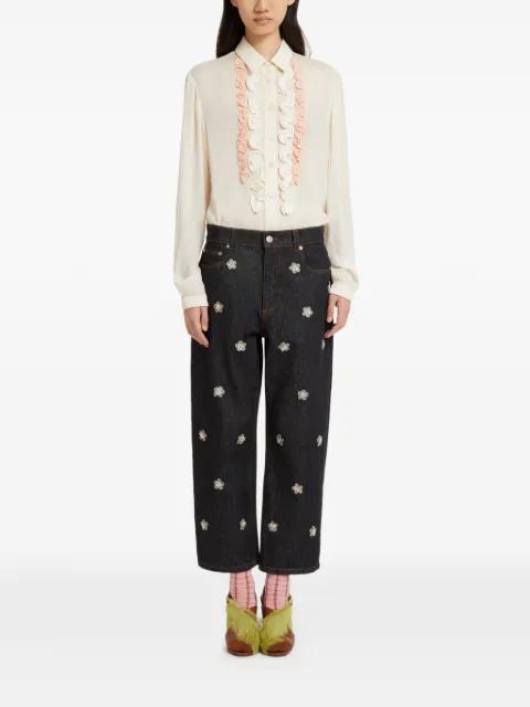 denim jeans with daisy appliqués by MARNI