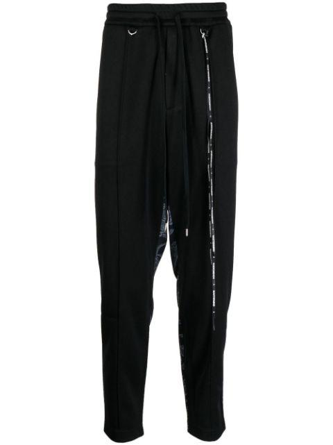 camouflage-print track pants by MASTERMIND