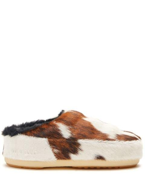 cow-print pony hair mules by MOON BOOT