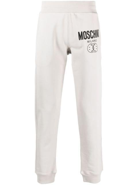 Smiley-print logo track trousers by MOSCHINO